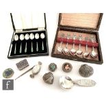 A small parcel lot of silver and white metal items to include a set of six tea spoons with enamel