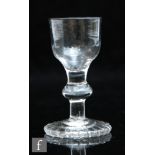 An 18th Century dram glass circa 1780, the ogee bowl with basal fluting above a plain stem with