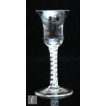 An 18th Century drinking glass circa 1765, the bell form bowl above a double series opaque twist