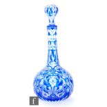 An early 20th Century Baccarat cameo glass decanter of bottle form with ball and shaft stopper,