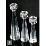 A graduated set of three Kosta Boda crystal glass candlesticks by Bengt Edenfalk in the Sapphire