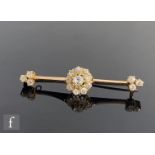 An early 20th Century gold and diamond set bar brooch, central cluster of old cut, claw set diamonds