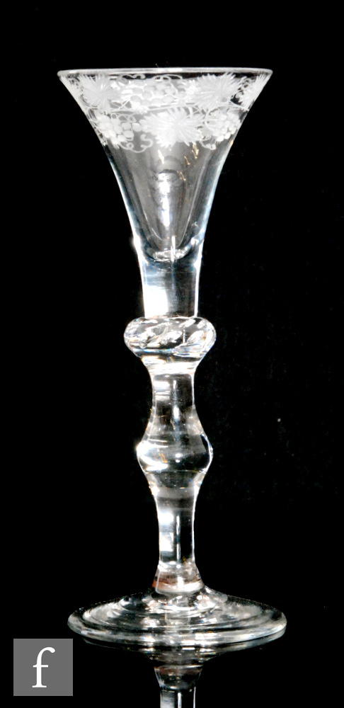 An 18th Century drinking glass circa 1740, the drawn trumpet bowl with a vine engraved upper