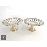 A pair of hallmarked silver pedestal bowls, circular stepped foot below pieced sides and stylised