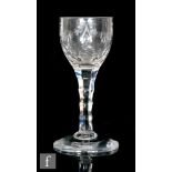 An 18th Century drinking glass circa 1785, the round funnel bowl engraved with a swag border of