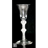 An 18th Century drinking glass circa 1760, the bell bowl above a double knopped, single series