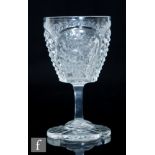 An early 20th Century Hawkes wine glass, the ovoid bow intaglio cut and polished with flowers
