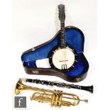 A ukele, unnamed, in black leather case, a brass cornet and an ebonised clarinet with plated