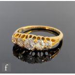 An 18ct boat shaped graduating diamond five stone ring, old cut claw set stones to tapering