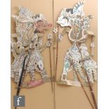 Two Indonesian Wayang theatre paper puppets, each of the characters mounted on sticks, approximate