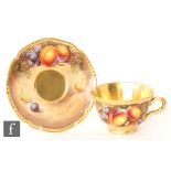 A later 20th Century Royal Worcester Fallen Fruits teacup and saucer, both decorated with hand