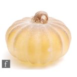 A contemporary glass model of a pumpkin, the pale orange body with an applied white textured finish,