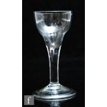 An 18th Century wine glass circa 1740, the double ogee bowl above a teared stem and raised to a