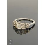 An early 20th Century platinum diamond ring, central transitional claw set stone, weight