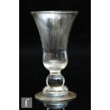 An 18th Century gin glass circa 1750, the bell bowl above a short stem with spherical knop and