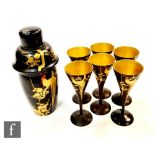 A Japanese Art Deco style cocktail shaker with six matching champagne flutes, the black lacquered