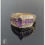 A 9ct hallmarked amethyst and diamond ring, central marquise cut amethyst flanked by further