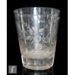 A pair of early 19th Century over sized clear glass tumblers with engraved floral garlands and wheat