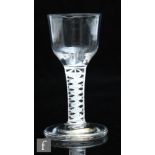 An 18th Century dram glass circa 1765, the ogee bowl above a double series opaque twist stem with