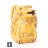 A late 19th Century jug formed as a bear with muzzle spout and raised arms decorated in an all