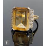 An 18ct citrene and diamond ring, central emerald cut citrene length 14mm, flanked by five brilliant