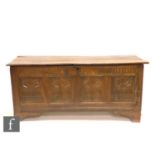 An early 18th century quadruple panelled oak coffer, the lunette frieze over a fan decorated