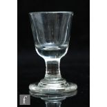 A late 18th Century dram glass circa 1780, the round funnel bowl above a short capstan stem and