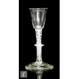 An 18th Century drinking glass circa 1750, the round funnel bowl above a multi series air twist