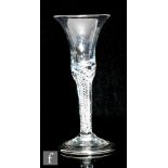 An 18th Century drinking glass circa 1740, the waisted bell bowl above a multi spiral air twist