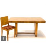 An Art Deco walnut dining table in the manner of Epstein, the table of rounded rectangular form