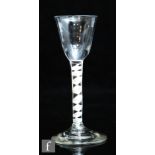 An 18th Century drinking glass circa 1765, the pointed round funnel bowl above a single series