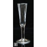 An 18th Century ratafia glass circa 1765, the tall round funnel bowl above a plain stem and raised a