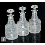 A set of three 19th Century decanters in the Regency taste, each of cylinder form with bands of