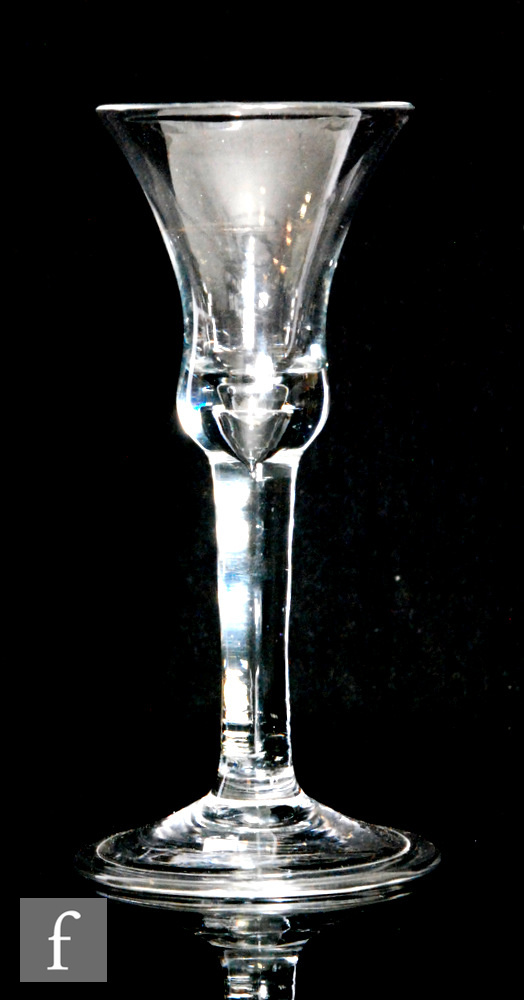 A 18th Century drinking glass circa 1740, the bell shaped bowl above a plain stem with internal
