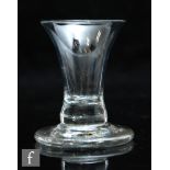 An 18th Century firing glass circa 1750, the flared bowl above a solid firing foot, height 8.5cm.
