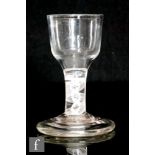 An 18th Century Firing glass circa 1770, the ogee bowl above a double series opaque twist stem