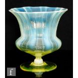 An early 20th Century John Walsh Walsh glass vase of waisted footed form, the ribbed bowl with