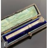 A 19th Century white metal slide dip pen with purple stone set terminal and foliate engraved