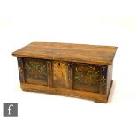 A 19th Century triple panelled pine coffer with painted floral detail to the front and sides, raised