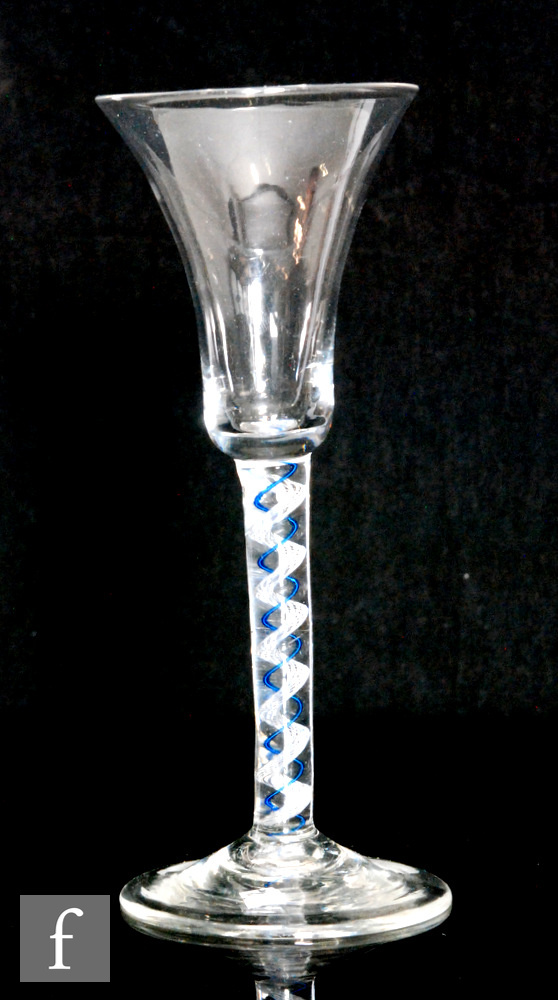 An 18th Century colour twist drinking glass circa 1770, the waisted bell bowl above a colour twist