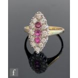 A 9ct ruby and diamond cluster ring, three vertically set rubies within a diamond surround all to