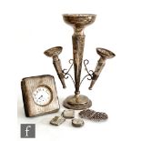 Six items of hallmarked silver to include two vesta cases, a three trumpet epergne, a silver fronted