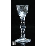 An 18th Century wine glass circa 1760, the ogee bowl engraved with a fruiting vine with a bird in