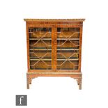 An early 20th Century mahogany double door cabinet in the Chippendale style, with astragal glazed