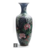 An exceptionally large Japanese cloisonne vase of ovoid form extending to a flared rim, the dark