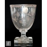 An 18th Century rummer circa 1780, the cup form bowl engraved with a lambrequin border and floral