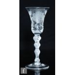 An 18th Century Jacobite drinking glass circa 1750, bell form bowl engraved with a rose on leaf