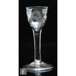 An 18th Century wine glass circa 1760, the ogee bowl engraved with flowers above a plain stem and