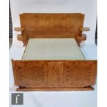 An Art Deco French burr walnut veneered double bed by Georges & Gaston Guerin, with an arched head