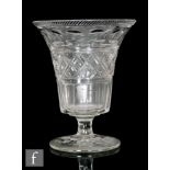 A 19th clear cut crystal vase of flared pedestal form with a band of printie panels above a